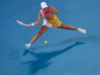 Iga Swiatek of Poland plays a forehand return to Madison Keys of the U.S. during their semifinal match at the Australian Open tennis championship in Melbourne, Australia, Thursday, Jan. 23, 2025. (AP Photo/Manish Swarup)