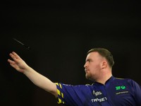 Luke Littler of England throws his dart during the semifinal match against Stephen Bunting of England, at the World Darts Championship in London, Thursday, Jan. 2, 2025. (AP Photo/Kirsty Wigglesworth)