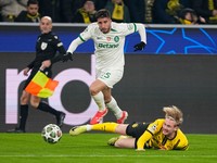 Dortmund's Julian Brandt tackles Sporting's Goncalo Inacio during the Champions League playoff second leg soccer match between Borussia Dortmund and Sporting CP at the Signa-Iduna Park in Dortmund, Germany, Wednesday, Feb. 19, 2025. (AP Photo/Martin Meissner)