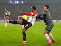 Feyenoord's Quinten Timber kicks the ball next to AC Milan's Tijjani Reijnders during the Champions League playoff first leg soccer match between Feyenoord and AC Milan, at the De Kuip stadium, in Rotterdam, Netherlands, Wednesday, Feb. 12, 2025. (AP Photo/Peter Dejong)

- XCHAMPIONSLEAGUEX