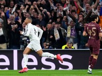 Real Madrid's Kylian Mbappe runs to celebrate after scoring his sides first goal during the Champions League playoff second leg soccer match between Real Madrid and Manchester City at the Santiago Bernabeu Stadium in Madrid, Spain, Wednesday, Feb. 19, 2025. (AP Photo/Manu Fernandez)

- XCHAMPIONSLEAGUEX