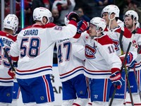 Montreal Canadiens' David Savard (58) and Brendan Gallagher (11) celebrate defeating the Vancouver Canucks after an NHL hockey game in Vancouver, B.C., on Tuesday, March 11, 2025.  (Ethan Cairns/The Canadian Press via AP)