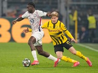 Lille's Ngal'ayel Mukau, left, controls the ball as Dortmund's Daniel Svensson tries to stop him during the Champions League round of 16 first leg soccer, between Borussia Dortmund and Lille at the Signa-Iduna Park in Dortmund, Germany, Tuesday, March 4, 2025. (AP Photo/Martin Meissner)