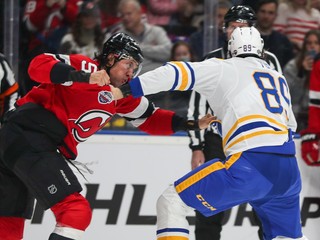 Brenden Dillon (NJ) a Alex Touch (Buffalo) v pästnom súboji po faule na Peterku.
