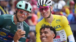 A man takes a selfie with Slovenia's Tadej Pogacar, wearing the overall leader's yellow jersey, and Italy's Jonathan Milan, wearing the best sprinter's green jersey, prior to the start of the fourteenth stage of the Tour de France cycling race over 182.6 kilometers (113.5 miles) with start in Pau and finish in Luchon-Superbagneres, France, Saturday, July 19, 2025. (AP Photo/Thibault Camus)