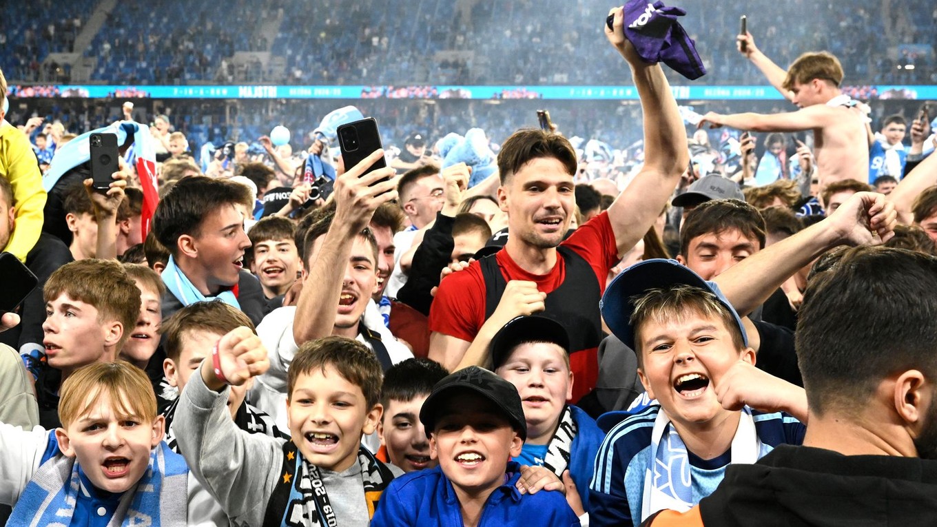 Brankár Slovana Dominik Takáč (červený dres) sa teší s divákmi zo zisku rekordného 15. titulu v najvyššej slovenskej futbalovej súťaži.