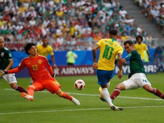 Mexický brankár Guillermo Ochoa zasahuje pri šanci Neymara.