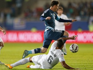 Messi sa snaží vyhnúť ležiacemu uruguajskému hráčovi.