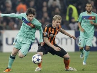 Lionel Messi (vľavo) bojuje o loptu s hráčom Šachtaru Tomášom Hübschmanom.