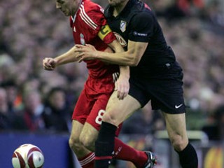 Steven Gerrard, kapitán Liverpoolu v červenom a Alvaro Dominguez z Atlética Madrid.