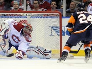 Jaroslav Halák (vľavo) z Montreal Canadiens zasahuje proti českému hráčovi New York Islanders Radek Martínek.