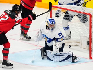 Canada's Dylan Cozens, left, celebrates after scoring his sides first goal past Finland's goalkeeper Harri Sateri during the preliminary round match between Canada and Finland at the Ice Hockey World Championships in Prague, Czech Republic, Saturday, May 18, 2024. (AP Photo/Petr David Josek)