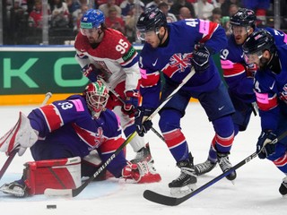 Britain's goalkeeper Ben Bowns, left, makes a save against Czech Republic's Daniel Vozenilek, 2nd left, during the preliminary round match between Czech Republic and Great Britain at the Ice Hockey World Championships in Prague, Czech Republic, Saturday, May 18, 2024. (AP Photo/Petr David Josek)