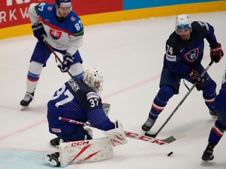 France's goalkeeper Sebastian Ylonen, left, makes a save during the preliminary round match between France and Slovakia at the Ice Hockey World Championships in Ostrava, Czech Republic, Saturday, May 18, 2024. (AP Photo/Darko Vojinovic)