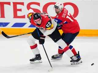 Norway's Eirik Salsten, right, challenges Austria's Paul Haber during the preliminary round match between Norway and Austria at the Ice Hockey World Championships in Prague, Czech Republic, Sunday, May 19, 2024. (AP Photo/Petr David Josek)