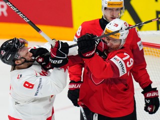 Canada's Michael Bunting, left, fights with Switzerland's Calvin Thurkauf during the preliminary round match between Canada and Switzerland at the Ice Hockey World Championships in Prague, Czech Republic, Sunday, May 19, 2024. (AP Photo/Petr David Josek)