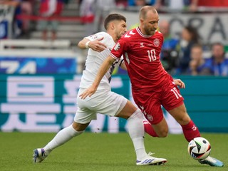 Denmark's Christian Eriksen, right, is tackled Slovenia's Erik Janza during a Group C match between Slovenia and Denmark at the Euro 2024 soccer tournament in Stuttgart, Germany, Sunday, June 16, 2024. (AP Photo/Matthias Schrader)

- XEURO2024X
