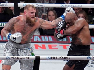 Jake Paul hits Mike Tyson during their heavyweight boxing match, Friday, Nov. 15, 2024, in Arlington, Texas. (AP Photo/Julio Cortez)