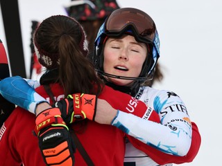 United States' Breezy Johnson, left, hugs teammate United States' Mikaela Shiffrin at the finish area of a slalom run of a women's team combined event, at the Alpine Ski World Championships, in Saalbach-Hinterglemm, Austria, Tuesday, Feb. 11, 2025. (AP Photo/Marco Trovati)