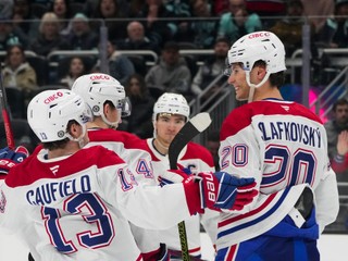 Montreal Canadiens left wing Juraj Slafkovsky (20) celebrates his goal against the Seattle Kraken with teammates, including right wing Cole Caufield (13) during the third period of an NHL hockey game Wednesday, March 12, 2025, in Seattle. (AP Photo/Lindsey Wasson)