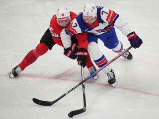 Switzerland's Sven Andrighetto, left, and United States' Michael Kesselring fight for the puck during the final match between United States and Switzerland at the ice hockey world championships in Stockholm, Sweden, Sunday, May 25, 2025. (AP Photo/Petr David Josek)