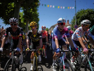 Belgium's Tim Wellens, Belgium's Victor Campenaerts, Canada's Michel Woods and France's Lenny Martinez, wearing the best climber's dotted jersey,, from left, ride during the twelfth stage of the Tour de France cycling race over 180.6 kilometers (112.2 miles) with start in Auch and finish in Hautacam, France, Thursday, July 17, 2025. (AP Photo/Thibault Camus)