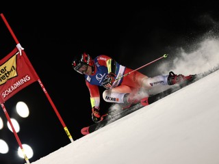 Switzerland's Gino Caviezel speeds down the course during an alpine ski, men's World Cup giant slalom in Schladming, Austria, Tuesday, Jan. 27, 2026. (AP Photo/Gabriele Facciotti)