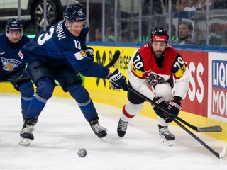 Austria's Benjamin Nissner, right, vies for the puck against Finland's Sakari Manninen, left, and Finland's Jesse Puljujarvi, center, during the 2026 IIHF Men's Ice Hockey World Championship preliminary round group A game between Finland and Austria, in Zurich, Switzerland, Sunday, May 24, 2026. (Andreas Becker/Keystone via AP)