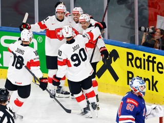 Switzerland's Sven Andrighetto, center, celebrates with Pius Suter, center left, and Denis Malgin, center right, and teammates after scoring his team's second goal during a Group A preliminary round game between United States and Switzerland at the men's ice hockey world championship in Zurich, Switzerland, Friday, May 15, 2026. (Michael Buholzer/Keystone via AP)