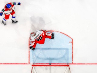 Czechia's Daniel Vozenilek, left, celebrates his goal past Denmark's goaltender Mads Sogaard during a Group B preliminary round game between the Czech Republic and Denmark at the men's ice hockey world championship in Fribourg, Switzerland, Friday, May 15, 2026. (Anthony Anex/Keystone via AP)