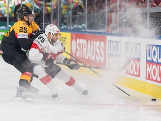 Germany's Leon Huttl, left, vies for the puck against Switzerland's Sven Andrighetto during the 2026 IIHF Men's Ice Hockey World Championship preliminary round group A game between Germany and Switzerland, in Zurich, Switzerland, Monday, May 18, 2026. (Claudio Thoma/Keystone via AP)