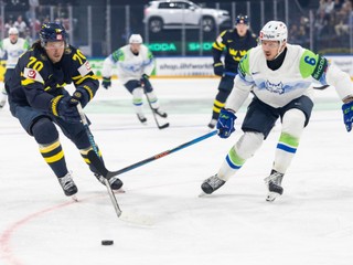 Sweden's Oskar Sundqvist, left, vies for the puck against Slovenia's Miha Stebih, right, during the 2026 IIHF Men's Ice Hockey World Championship preliminary round group B game between Sweden and Slovenia, in Fribourg, Switzerland, Wednesday, May 20, 2026. (Cyril Zingaro/Keystone via AP)