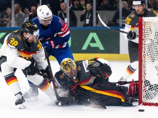 Germany's Fabio Wagner, from left, USA's Matt Coronato, Germany's goaltender Philipp Grubauer and Germany's Leon Huttl vie for the puck during the 2026 IIHF Men's Ice Hockey World Championship preliminary round group A game between United States and Germany, in Zurich, Switzerland, Wednesday, May 20, 2026. (Andreas Becker/Keystone via AP)
