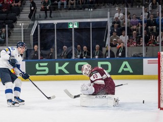 Finland's Saku Maenalanen, left, scores against Latvia's goaltender Mareks Mitens during a Group A preliminary round game between Latvia and Finland at the men's ice hockey world championship in Zurich, Switzerland, Thursday, May 21, 2026. (Alessandro della Valle/Keystone via AP)