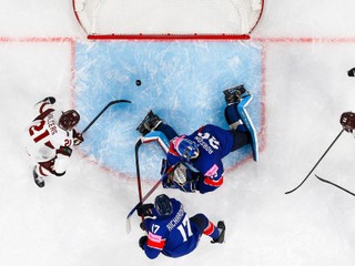 Latvia's Rudolfs Balcers, left, scores his side's third goal during the 2026 IIHF Men's Ice Hockey World Championship preliminary round group A match between Great Britain and Latvia in Zurich, Switzerland, Sunday, May 24, 2026. (Andreas Becker/Keystone via AP)