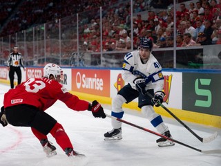 Switzerland's Theo Rochette, left, and Finland's Ville Heinola in acition during a preliminary round game between Switzerland and Finland at the men's ice hockey world championship in Zurich, Switzerland, Tuesday May 26, 2026. (Claudio Thoma/Keystone via AP)