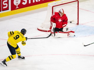 Sweden's Linus Karlsson, left, scores past Switzerland's goaltender Leonardo Genoni, right, during tha quarterfinal game between Switzerland and Sweden at the men's ice hockey world championship in Zurich, Switzerland, Thursday, May 28, 2026. (Andreas Becker/Keystone via AP)
