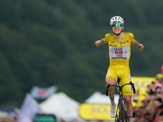 Slovenia's Tadej Pogacar, wearing the overall leader's yellow jersey, celebrates as he crosses the finish line to win the fourteenth stage of the Tour de France cycling race with start in Mulhouse and finish in Le Markstein Fellering, France, Saturday, July 18, 2026. (AP Photo/Mosa'ab Elshamy)