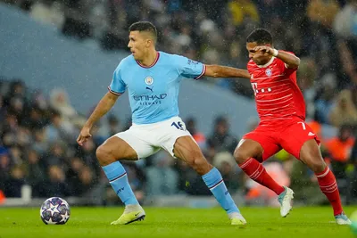 Manchester City's Rodrigo, left, fights for the ball with Bayern's Serge Gnabry during the Champions League quarterfinal, first leg, soccer match between Manchester City and Bayern Munich at the Etihad stadium in Manchester, England, Tuesday, April 11, 2023. (AP Photo/Jon Super)

- XCHAMPIONSLEAGUEX
