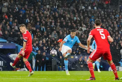 Manchester City's Rodrigo, center, scores his side's opening goal during the Champions League quarterfinal, first leg, soccer match between Manchester City and Bayern Munich at the Etihad stadium in Manchester, England, Tuesday, April 11, 2023. (AP Photo/Jon Super)

- XCHAMPIONSLEAGUEX