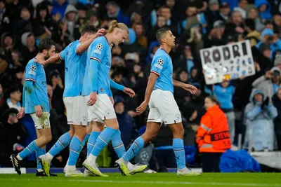 Manchester City's Rodrigo, right, celebrates with his teammates after scoring his side's opening goal during the Champions League quarterfinal, first leg, soccer match between Manchester City and Bayern Munich at the Etihad stadium in Manchester, England, Tuesday, April 11, 2023. (AP Photo/Jon Super)

- XCHAMPIONSLEAGUEX