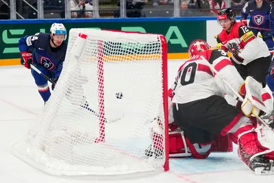France's Tim Bozon, left, scores the opening goal past Austria's goalie David Madlener during the group A match between France and Austria at the ice hockey world championship in Tampere, Finland, Saturday, May 13, 2023. (AP Photo/Pavel Golovkin)