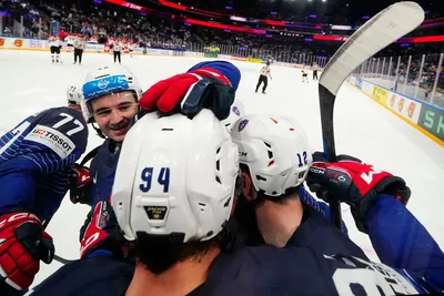 France's team players celebrate as Tim Bozon, centre back to the camera, scored the opening goal during the group A match between France and Austria at the ice hockey world championship in Tampere, Finland, Saturday, May 13, 2023. (AP Photo/Pavel Golovkin)