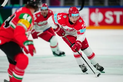 Denmark's Morten Jensen, right, controls the puck during the group A match between Hungary and Denmark at the ice hockey world championship in Tampere, Finland, Saturday, May 13, 2023. (AP Photo/Pavel Golovkin)