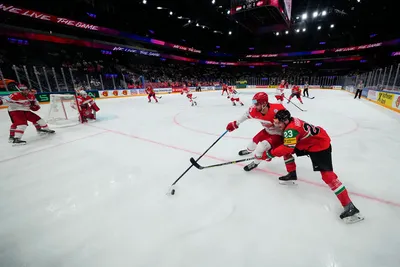 Hungary's Zeteny Hadobas, right, and Denmark's Mathias Bau battle for the puck during the group A match between Hungary and Denmark at the ice hockey world championship in Tampere, Finland, Saturday, May 13, 2023. (AP Photo/Pavel Golovkin)