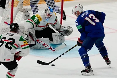 United States Nick Bonino, right, scores his side's second goal past Hungary's goalie Dominik Horvath during the group A match between United States and Hungary at the ice hockey world championship in Tampere, Finland, Sunday, May 14, 2023. (AP Photo/Pavel Golovkin)