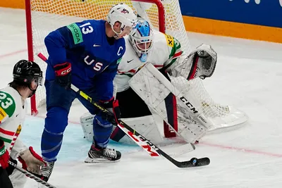 United States Nick Bonino, centre, battles for the puck before scoring his side's third goal past Hungary's goalie Dominik Horvath during the group A match between United States and Hungary at the ice hockey world championship in Tampere, Finland, Sunday, May 14, 2023. (AP Photo/Pavel Golovkin)