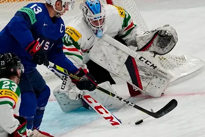 United States Nick Bonino, left, battles for the puck before scoring his side's third goal past Hungary's goalie Dominik Horvath during the group A match between United States and Hungary at the ice hockey world championship in Tampere, Finland, Sunday, May 14, 2023. (AP Photo/Pavel Golovkin)