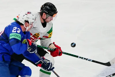United States Michael Eyssimont, left, and Hungary's Kristof Papp battle for the puck during the group A match between United States and Hungary at the ice hockey world championship in Tampere, Finland, Sunday, May 14, 2023. (AP Photo/Pavel Golovkin)