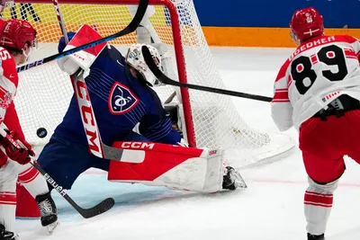 Denmark's Mikkel Boedker, right, scores his side's second goal past France's goalie Sebastian Ylonen during the group A match between France and Denmark at the ice hockey world championship in Tampere, Finland, Sunday, May 14, 2023. (AP Photo/Pavel Golovkin)